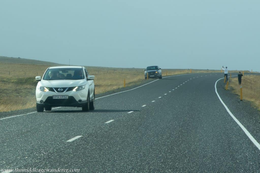 A car stopped in the middle of the Ring Road, Iceland's main highway. The passengers were taking photos.